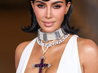 Kim Kardashian wearing a custom Gucci dress and coat with a Tallarico pearl choker, Bvlgari pearl and diamond necklace, and Princess Diana's...