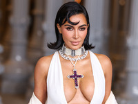 Kim Kardashian wearing a custom Gucci dress and coat with a Tallarico pearl choker, Bvlgari pearl and diamond necklace, and Princess Diana's...