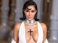 Kim Kardashian wearing a custom Gucci dress and coat with a Tallarico pearl choker, Bvlgari pearl and diamond necklace, and Princess Diana's...