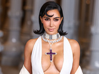 Kim Kardashian wearing a custom Gucci dress and coat with a Tallarico pearl choker, Bvlgari pearl and diamond necklace, and Princess Diana's...