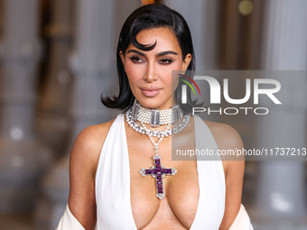 Kim Kardashian wearing a custom Gucci dress and coat with a Tallarico pearl choker, Bvlgari pearl and diamond necklace, and Princess Diana's...