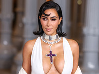 Kim Kardashian wearing a custom Gucci dress and coat with a Tallarico pearl choker, Bvlgari pearl and diamond necklace, and Princess Diana's...