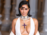 Kim Kardashian wearing a custom Gucci dress and coat with a Tallarico pearl choker, Bvlgari pearl and diamond necklace, and Princess Diana's...