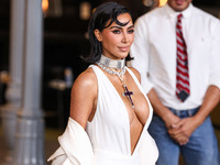 Kim Kardashian wearing a custom Gucci dress and coat with a Tallarico pearl choker, Bvlgari pearl and diamond necklace, and Princess Diana's...