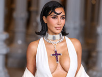 Kim Kardashian wearing a custom Gucci dress and coat with a Tallarico pearl choker, Bvlgari pearl and diamond necklace, and Princess Diana's...