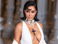 Kim Kardashian wearing a custom Gucci dress and coat with a Tallarico pearl choker, Bvlgari pearl and diamond necklace, and Princess Diana's...