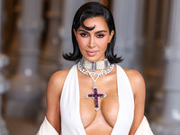 Kim Kardashian wearing a custom Gucci dress and coat with a Tallarico pearl choker, Bvlgari pearl and diamond necklace, and Princess Diana's...