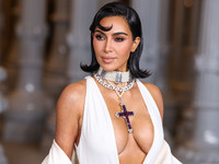 Kim Kardashian wearing a custom Gucci dress and coat with a Tallarico pearl choker, Bvlgari pearl and diamond necklace, and Princess Diana's...