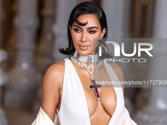 Kim Kardashian wearing a custom Gucci dress and coat with a Tallarico pearl choker, Bvlgari pearl and diamond necklace, and Princess Diana's...