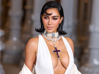 Kim Kardashian wearing a custom Gucci dress and coat with a Tallarico pearl choker, Bvlgari pearl and diamond necklace, and Princess Diana's...