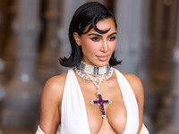 Kim Kardashian wearing a custom Gucci dress and coat with a Tallarico pearl choker, Bvlgari pearl and diamond necklace, and Princess Diana's...