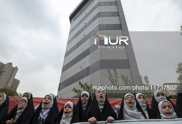 Veiled Iranian schoolgirls perform during an anti-U.S. and anti-Israel rally marking the anniversary of the U.S. embassy occupation at the f...