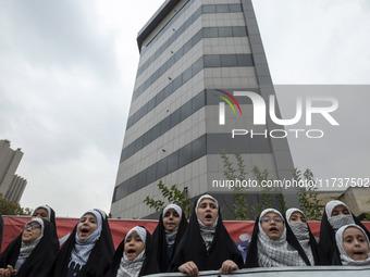 Veiled Iranian schoolgirls perform during an anti-U.S. and anti-Israel rally marking the anniversary of the U.S. embassy occupation at the f...