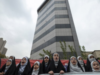 Veiled Iranian schoolgirls perform during an anti-U.S. and anti-Israel rally marking the anniversary of the U.S. embassy occupation at the f...