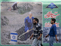 Iranian men walk past an anti-U.S. and anti-Israel banner featuring portraits of Israeli Prime Minister Benjamin Netanyahu and U.S. Presiden...