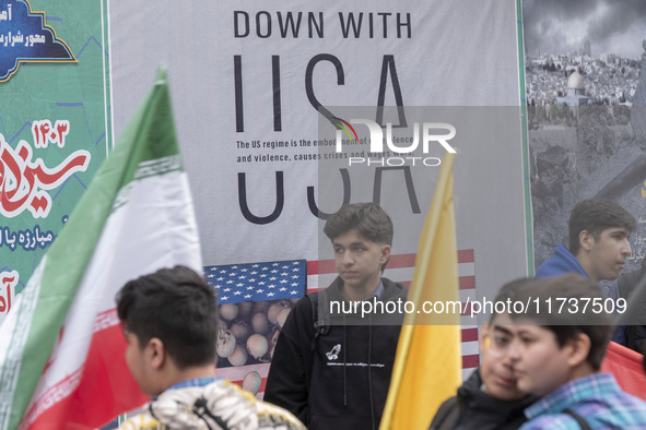 Young Iranian schoolboys stand in front of an anti-U.S. banner while participating in an anti-U.S. and anti-Israel rally marking the anniver...