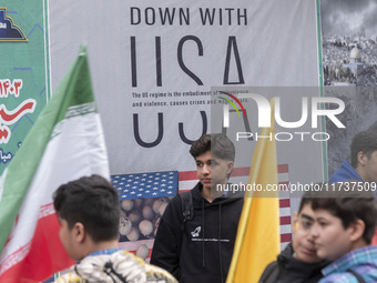 Young Iranian schoolboys stand in front of an anti-U.S. banner while participating in an anti-U.S. and anti-Israel rally marking the anniver...