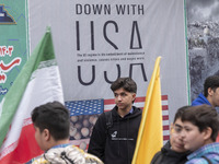 Young Iranian schoolboys stand in front of an anti-U.S. banner while participating in an anti-U.S. and anti-Israel rally marking the anniver...