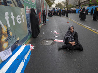 An Iranian woman sits next to an anti-Israeli installation art while participating in an anti-U.S. and anti-Israel rally marking the anniver...