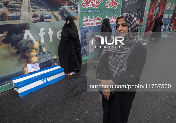 Iranian women stand next to an anti-Israeli installation art while participating in an anti-U.S. and anti-Israel rally marking the anniversa...