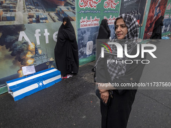 Iranian women stand next to an anti-Israeli installation art while participating in an anti-U.S. and anti-Israel rally marking the anniversa...