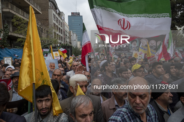 A man waves an Iranian flag while participating in an anti-U.S. and anti-Israel rally marking the anniversary of the U.S. embassy occupation...