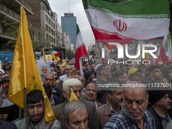 A man waves an Iranian flag while participating in an anti-U.S. and anti-Israel rally marking the anniversary of the U.S. embassy occupation...