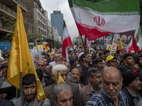 A man waves an Iranian flag while participating in an anti-U.S. and anti-Israel rally marking the anniversary of the U.S. embassy occupation...