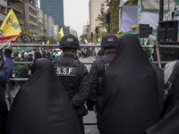 Two military personnel of the Islamic Revolutionary Guard Corps (IRGC) Special Force monitor an area during an anti-U.S. and anti-Israel ral...