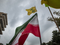 A demonstrator (not pictured) waves an Iranian flag and a flag of Lebanon Hezbollah while participating in an anti-U.S. and anti-Israel rall...