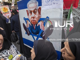 Veiled Iranian demonstrators stand together in front of an anti-Israeli Prime Minister, Benjamin Netanyahu, banner during an anti-U.S. and a...