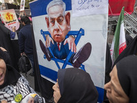 Veiled Iranian demonstrators stand together in front of an anti-Israeli Prime Minister, Benjamin Netanyahu, banner during an anti-U.S. and a...