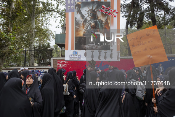 Veiled Iranian demonstrators stand together under an anti-Israeli Prime Minister, Benjamin Netanyahu, banner during an anti-U.S. and anti-Is...