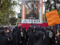 Veiled Iranian demonstrators stand together under an anti-Israeli Prime Minister, Benjamin Netanyahu, banner during an anti-U.S. and anti-Is...