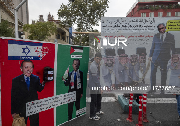 An Iranian demonstrator stands next to banners against Turkish President Recep Tayyip Erdogan during an anti-U.S. and anti-Israel rally mark...