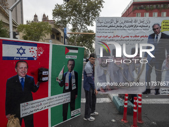 An Iranian demonstrator stands next to banners against Turkish President Recep Tayyip Erdogan during an anti-U.S. and anti-Israel rally mark...