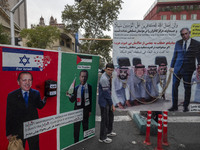 An Iranian demonstrator stands next to banners against Turkish President Recep Tayyip Erdogan during an anti-U.S. and anti-Israel rally mark...