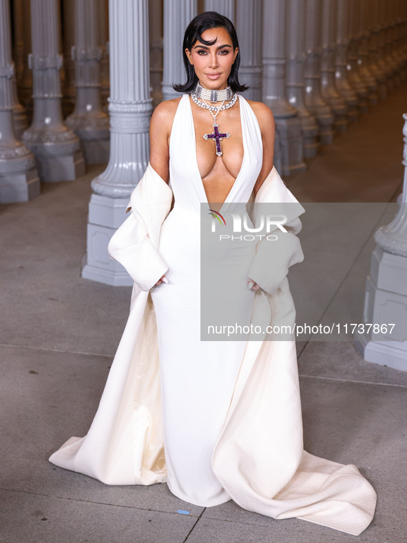 Kim Kardashian wearing a custom Gucci dress and coat with a Tallarico pearl choker, Bvlgari pearl and diamond necklace, and Princess Diana’s...