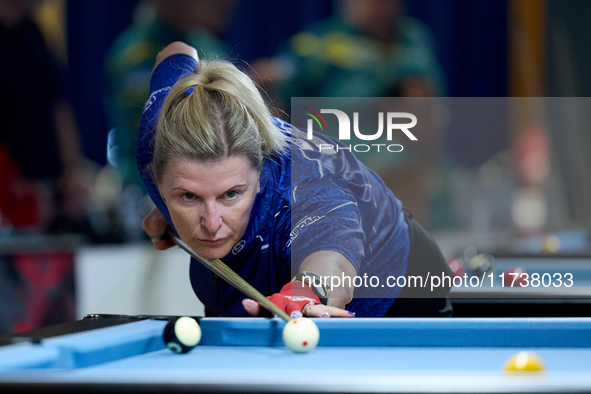 A participant from the Scotland Eightball Pool Federation ladies team performs during one of the events at the inaugural IBF World Blackball...