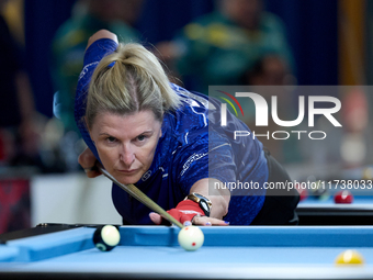 A participant from the Scotland Eightball Pool Federation ladies team performs during one of the events at the inaugural IBF World Blackball...