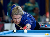 A participant from the Scotland Eightball Pool Federation ladies team performs during one of the events at the inaugural IBF World Blackball...