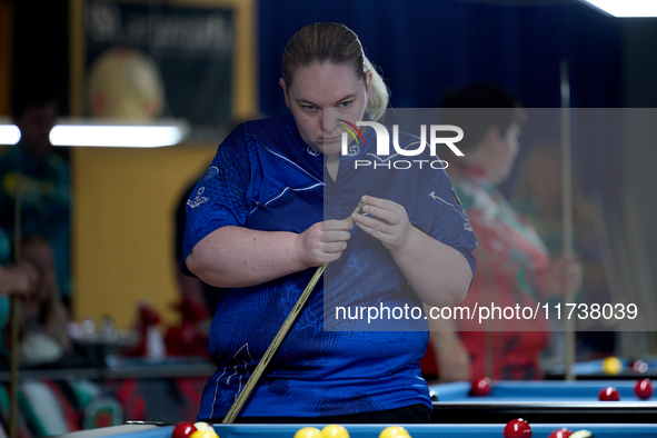 A participant from the Scotland Eightball Pool Federation ladies team gestures during one of the events at the inaugural IBF World Blackball...