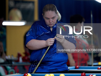 A participant from the Scotland Eightball Pool Federation ladies team gestures during one of the events at the inaugural IBF World Blackball...