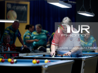 Lorna Micallef from the English Blackball Pool Federation ladies national team prepares the rack of balls before one of the events at the in...