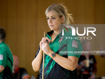 A blackball player from the Northern Ireland Pool Association ladies national team participates in one of the events at the inaugural IBF Wo...