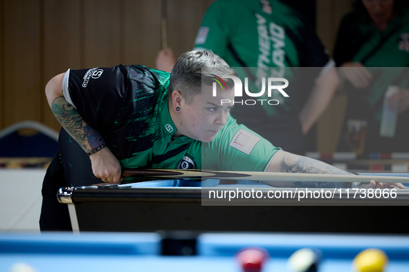 A blackball female player from the Northern Ireland Pool Association ladies national team participates in one of the events at the inaugural...