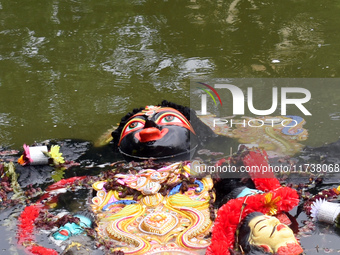 An idol of the Hindu goddess Kali floats after being immersed in a pond in Kolkata, India, on November 3, 2024. (