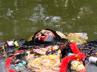 An idol of the Hindu goddess Kali floats after being immersed in a pond in Kolkata, India, on November 3, 2024. (