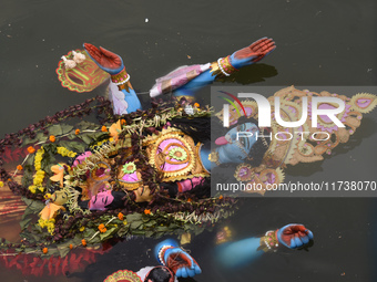 An idol of the Hindu goddess Kali floats after being immersed in a pond in Kolkata, India, on November 3, 2024. (