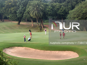 People play golf inside a golf course in Kolkata, India, on November 3, 2024. (